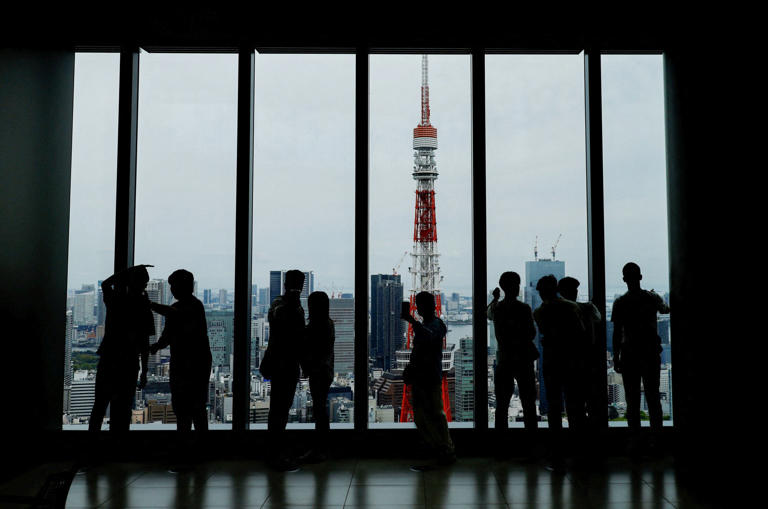 Visitors at an observation deck looking out on Azabudai Hills in Tokyo. Photo: Reuters