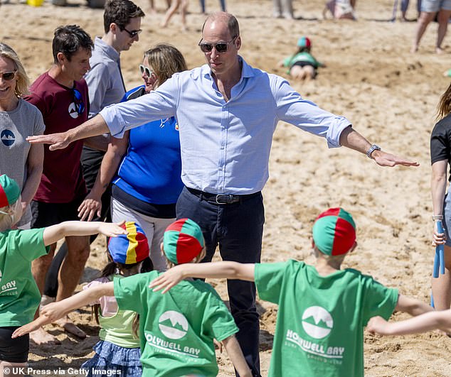 prince william on cornish surf beach playing volleyball