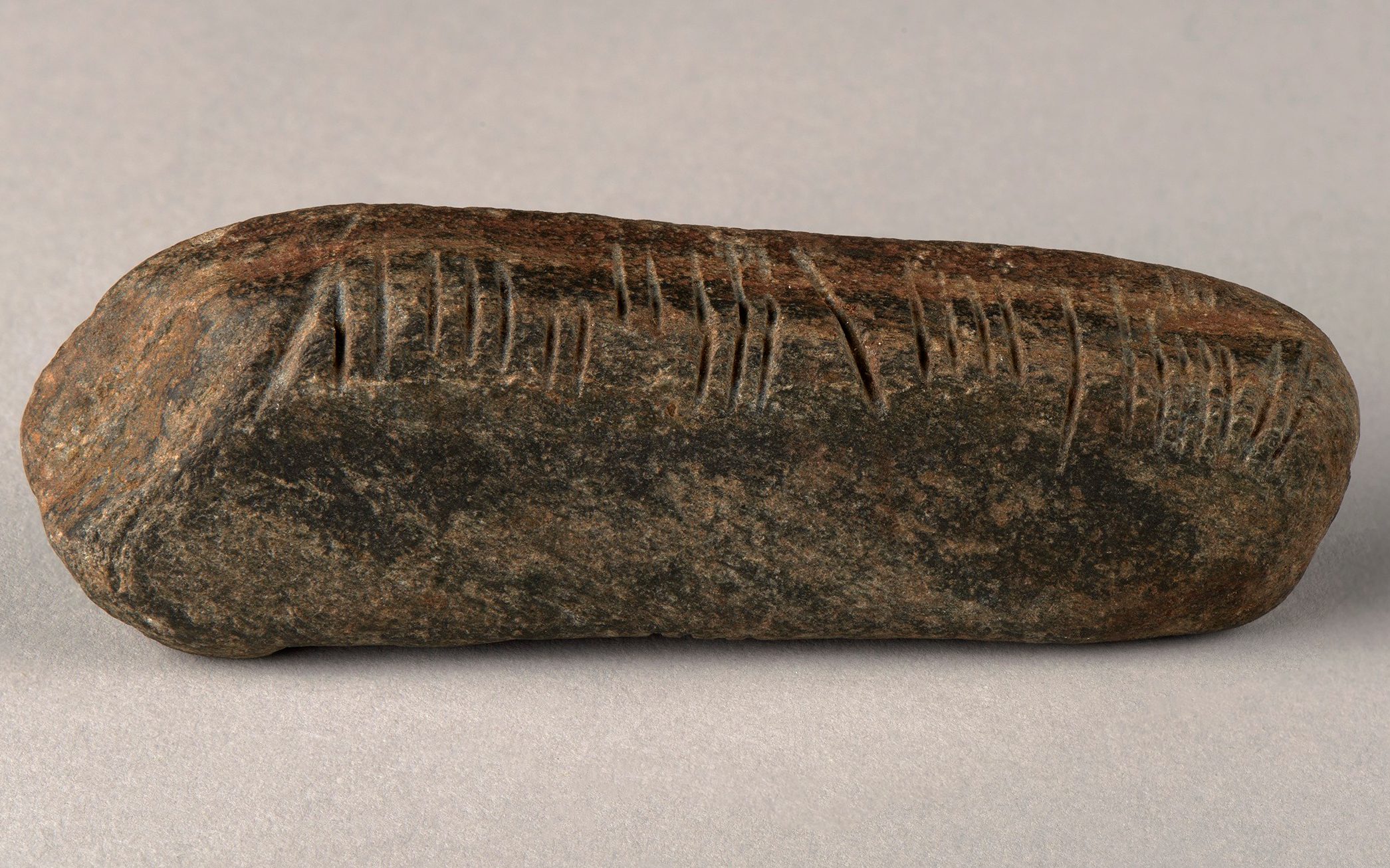 teacher finds ancient celtic script stone while weeding garden