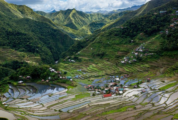 <p>The Ifugao people built the Banaue Rice Terraces over 2,000 years ago, and they are now often called the “Eighth Wonder of the World.” The design of this UNESCO World Heritage Site showcases their creativity and skill. They are still actively used for farming, primarily rice and vegetables. Visitors can enjoy the breathtaking view of terraces on the mountainside and local delicacies like traditional smoked meat called “kinuday.”</p>