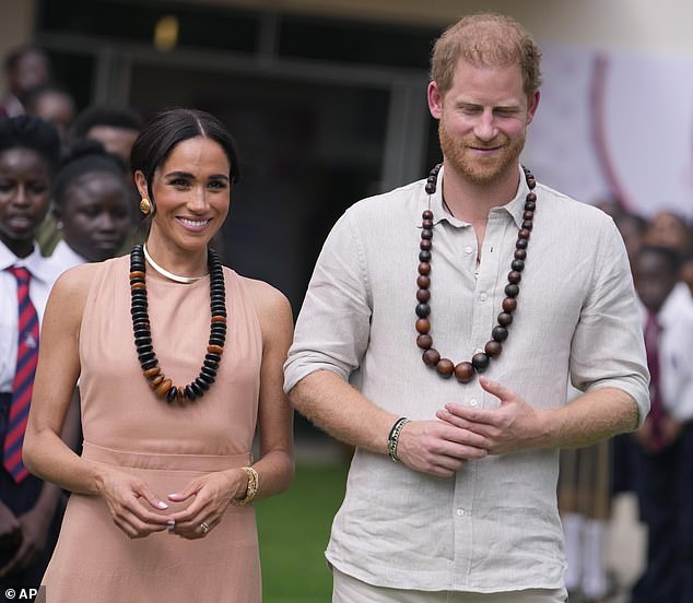 meghan sports backless dress as she joins harry in nigeria