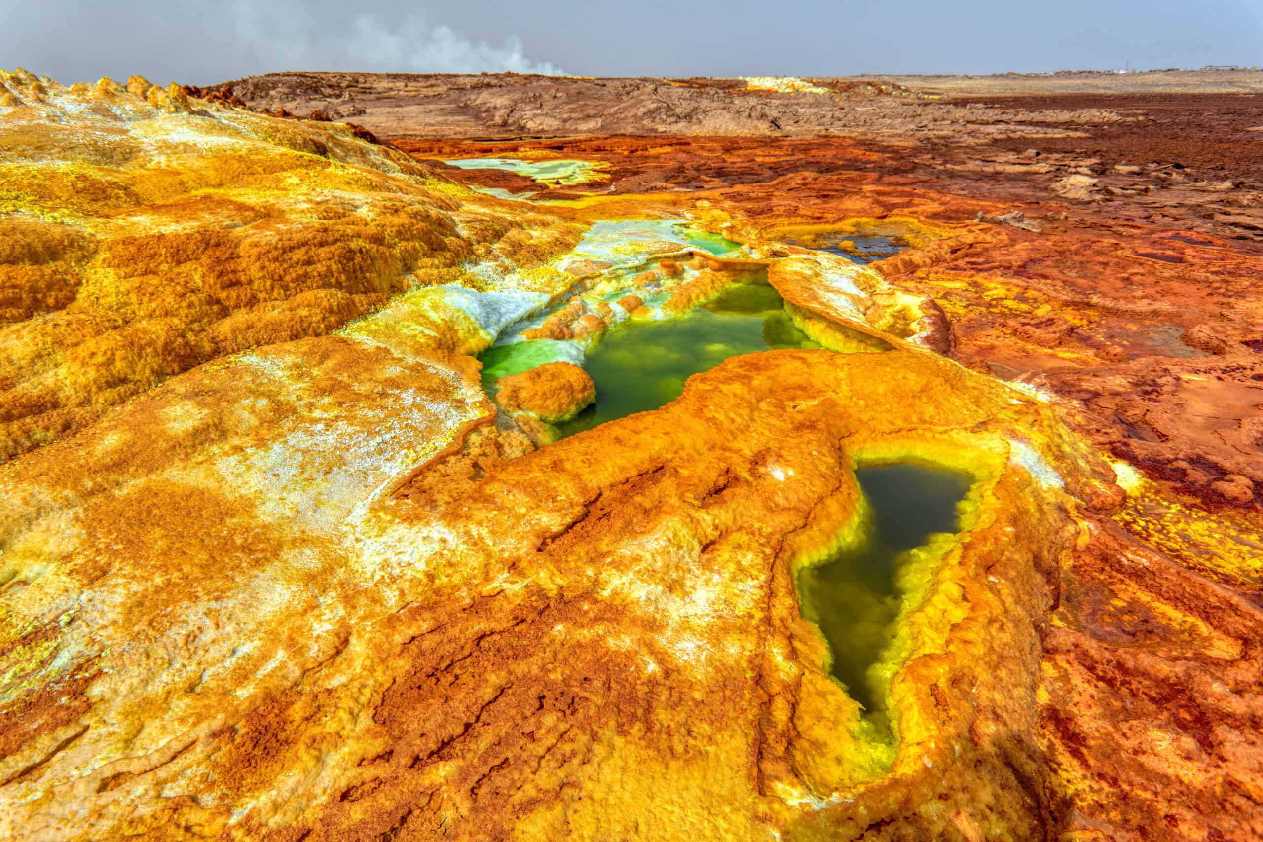 <p>Venture into the extreme environs of the Danakil Depression in Ethiopia, a place where the Earth’s raw power is on full display, creating a canvas of otherworldly landscapes. Approximately 410 feet below sea level, this plain is a geological wonder formed by the divergence of three tectonic plates, hinting at a future ocean as Africa slowly parts ways with the Horn. </p> <p>While it’s a hotbed of scientific intrigue, having revealed the ancient Australopithecus fossil “Lucy,” the depression’s vividly colored hot springs and vast salt flats also make it a stunningly harsh yet beautiful spectacle. Though travelers should heed current advisories, the Danakil Depression stands as a testament to our planet’s dynamic past and transformative future.</p>