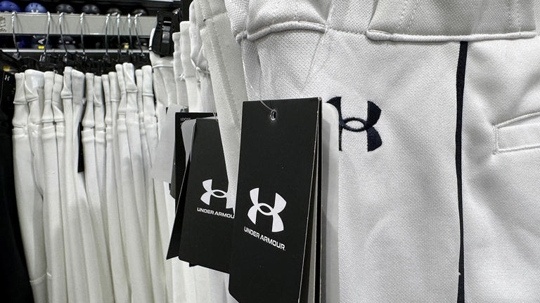 PETALUMA, CALIFORNIA - MAY 16: Under Armour apparel is displayed at a Dick's Sporting Goods store on May 16, 2024 in Petaluma, California. Under Armour reported fourth quarter earnings with revenue of $1.33 billion compared to $1.4 billion one year ago. The company also announced plans to layoff workers as North American sales fell 10 percent and don't forecast an improvement in the current fiscal year. (Photo by Justin Sullivan/Getty Images)