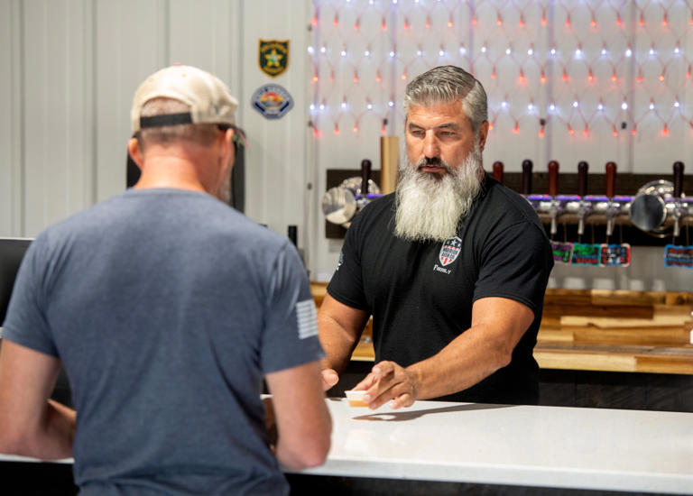 Jeff Witter gives a customer a tatse sample of beer at Warrior Beer Company at 10605 Sorrento Road. Sunday, May 5, 2024.