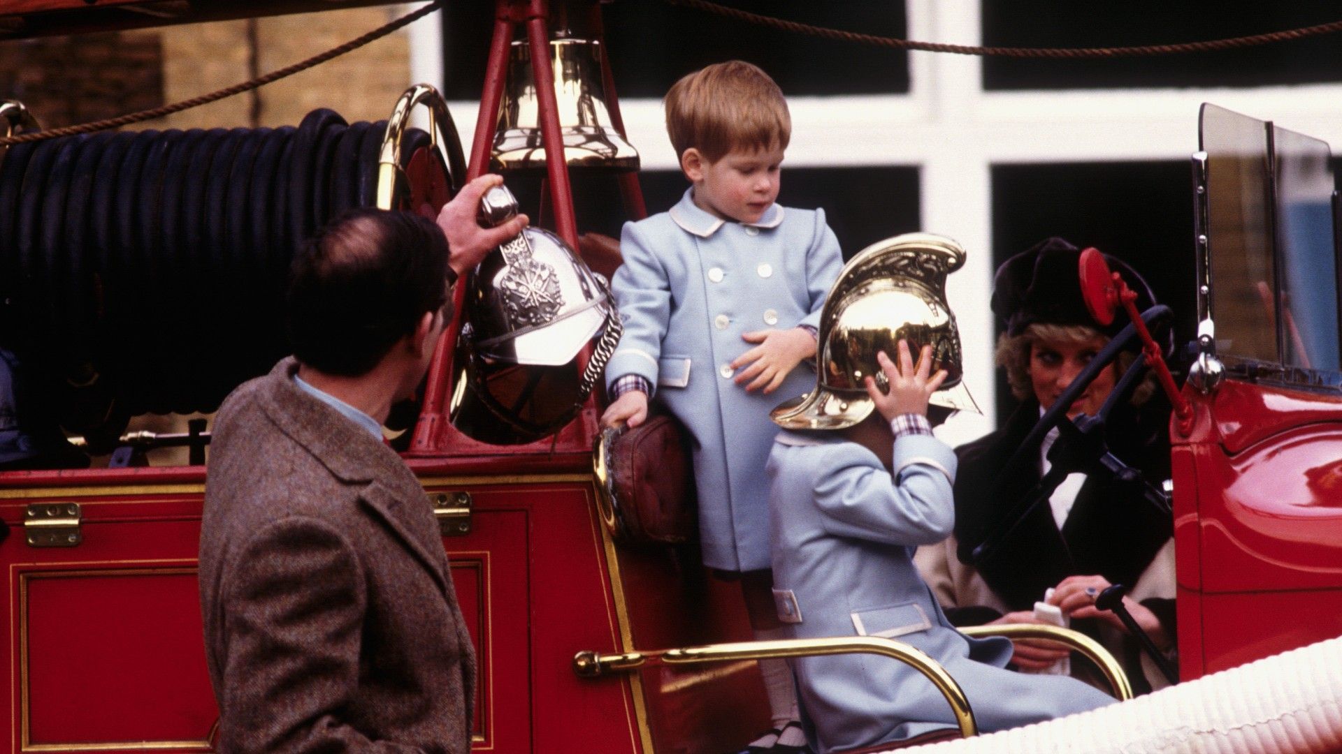 <p>                     Dressed in matching periwinkle blue coats, a young Prince William and Harry are snapped playing on a vintage fire engine on the Sandringham Estate in Norfolk in 1988.                   </p>                                      <p>                     Both look fascinated by the vintage vehicle as their father, King Charles, watches over his curious sons.                   </p>