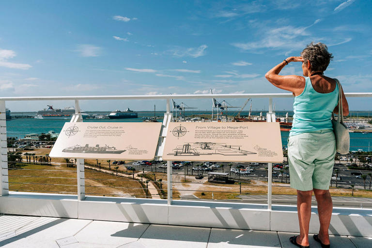 Port Canaveral, Florida, USA A female tourist standing at a vantage point to view the port activity