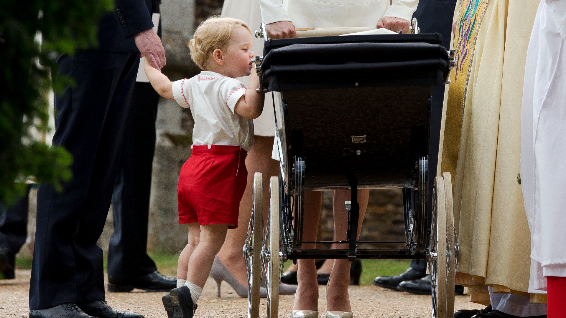 <p>                     This heart-warming photo might have been taken at the christening of Princess Charlotte, but it's George who stole hearts with his adorable, instinctive big brotherly nature shining through.                   </p>                                      <p>                     Having to stand on his tiptoes, the young Prince keeps a watchful eye over his younger sister as she is pushed around in her pram.                   </p>