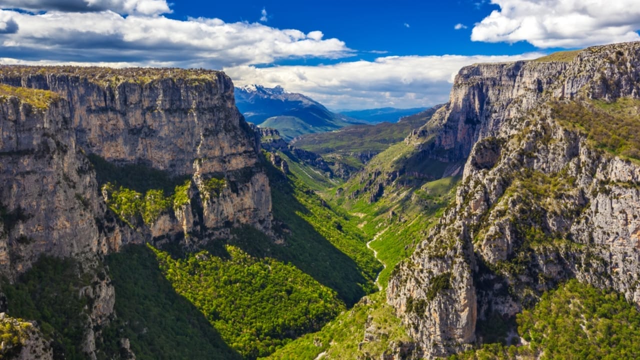 <p>Vikos Gorge, located in the Pindus Mountains of northern Greece, is listed in the Guinness Book of Records as the deepest gorge in the world in proportion to its width. The gorge measures over 3,000 feet deep but is just a few hundred feet wide at some points. </p> <p>The Vikos Gorge is a key component of the Vikos-Aoos National Park, known for its stunning mountainous landscapes and traditional stone villages. (<a href="https://www.yce.gr/en/visiting-epirus/vikos-gorge/">ref</a>)</p> <p>The gorge itself is a paradise for hikers, offering scenic trails that provide views of vertical cliffs and lush vegetation. The region is also a haven for wildlife, including several endangered species, making it a significant ecological site as well.</p>