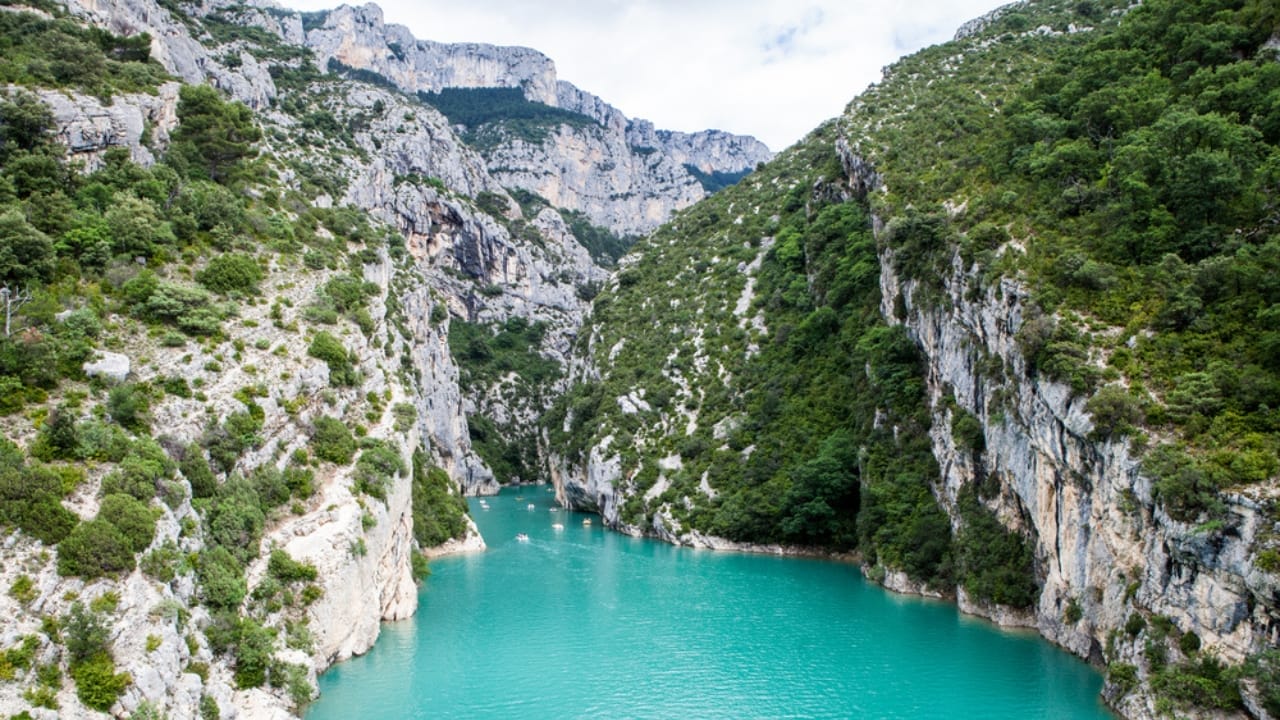 <p>Verdon Gorge, in southeastern France, is often referred to as Europe’s answer to the Grand Canyon. With its limestone walls reaching heights of up to 2,300 feet, the gorge is a stunning sight, particularly for its striking, turquoise-green river that flows at the bottom. </p> <p>This color comes from the minerals in the rocks, creating a vivid contrast with the stark white cliffs.</p> <p>The area is popular with tourists and offers numerous activities, including kayaking, climbing, and hiking. The Sentier Martel trail, in particular, offers hikers dramatic views of the high cliffs and the serene river below.</p>