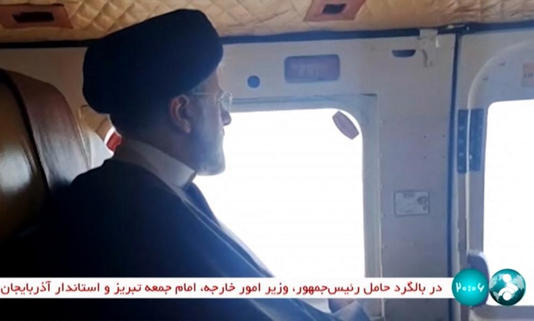 This grab taken from handout video footage released by the IRINN Iranian state television network on May 19, 2024 shows Iran's President Ebrahim Raisi on board a helicopter in the Jofa region of the western province of East Azerbaijan.