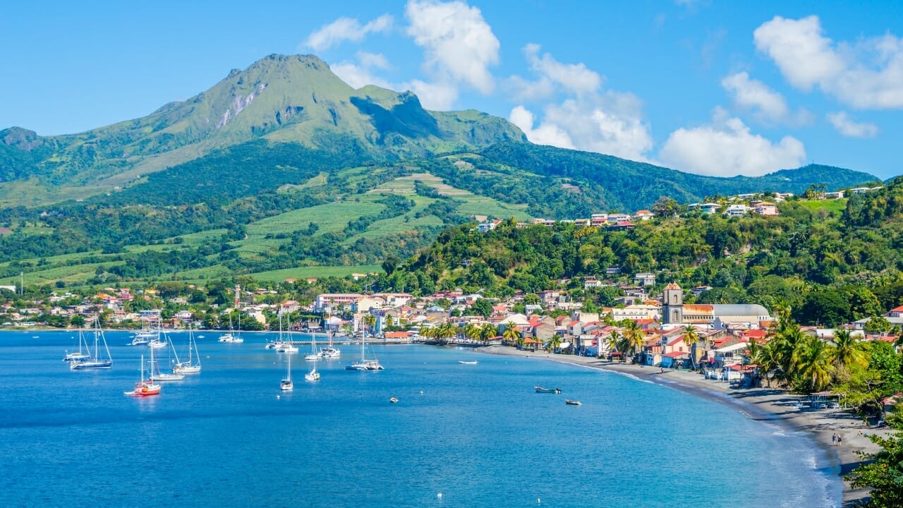 <p>Nearby Martinique shows off its own volcanic majesty, with the still-active Mt. Pelée looming above coastal villages like Saint Pierre rebuilt after destruction in 1902’s eruption. Beaches and reefs draw snorkelers and surfers.</p>