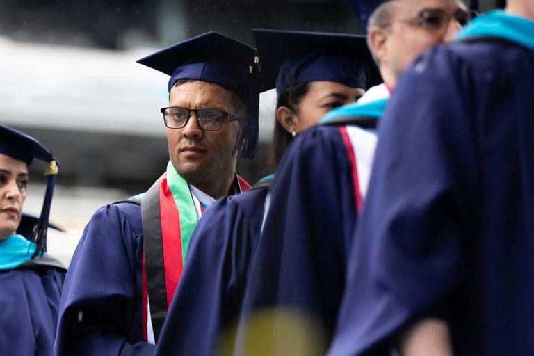 Hashmat Vejdani walks toward the stage to receive his diploma during Fairleigh Dickinson University's graduation ceremony on Wednesday, May 15, 2024 at MetLife Stadium in East Rutherford, New Jersey.