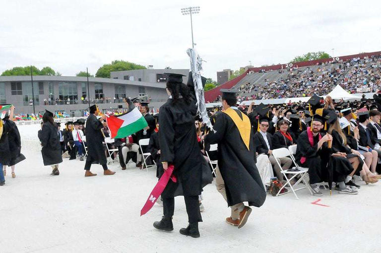Students walk out during the University of Massachusetts Amherst commencement.