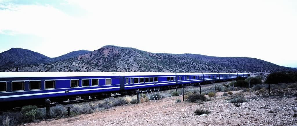 <p>If a seven-day trip is too long for you, choose a two-day trip! The Blue Train takes two nights to travel from Pretoria to Cape Town in South Africa and passes through beautiful sceneries. It is a luxury train, and passengers enjoy comfortable accommodations, good services, and food.</p>    <p>The train's windows are tinted to protect adventurers from direct sunlight, but you can view the beautiful landscapes, mountains, and lush forests.</p>    <p>The Blue Train takes two days and 3 hours to travel a 1,600 km journey from Pretoria to Cape Town, South Africa. The fare is 10,120 Rand per person, and the main stop is the Open Mine Museum. Throughout your journey, you will enjoy the beautiful views of Pretoria, Kimberly, and Cape Town.</p>    <ul> <li>Passengers travel to a five-star hotel on the rails and enjoy meals prepared by executive chefs.</li>    <li>Visits to fascinating Kimberly and Matjiesfontein.</li> </ul>