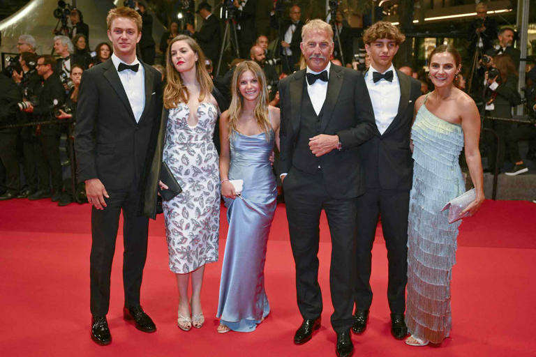 CHRISTOPHE SIMON/AFP via Getty Kevin Costner poses with five of his kids