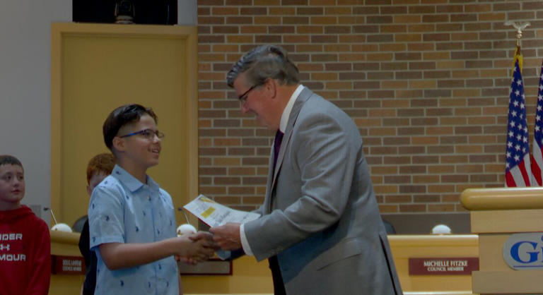 Mayor Steele awarding Saybel Raez Almaguer with first prize in the essay contest