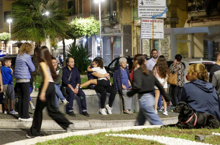 Concerned residents gather in a safe area along the seafront between Naples and Pozzuoli (Picture: IPA/SplashNews.com)