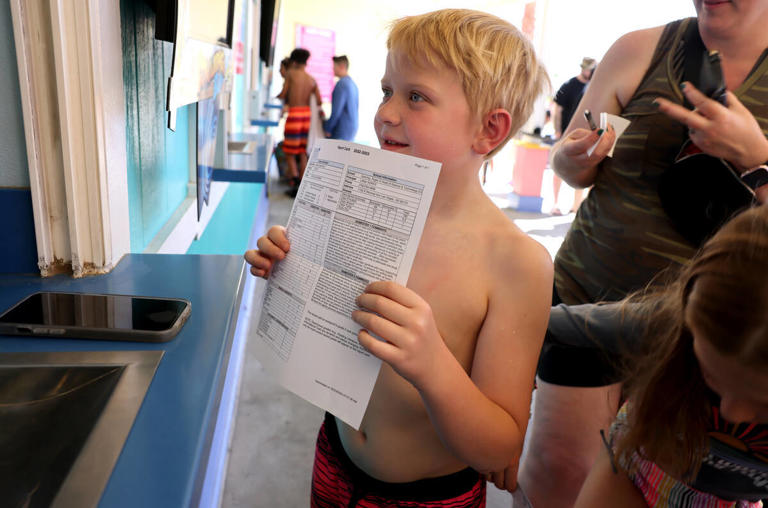 Gavin Andrade 8, of Las Vegas shows his report card for free admission at Cowabunga Bay in Henderson Tuesday, May 23, 2023. Students with a report card that included at least three A's received free admission to the water park. The promotion runs through Thursday, May 25 at both Cowabunga water parks. (K.M. Cannon/Las Vegas Review-Journal) @KMCannonPhoto