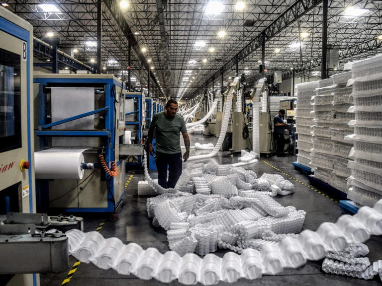 Several machines work nonstop making pocket springs of different sizes. The pile of narrow springs on the floor will be used on the edges to provide edge support. Jaclyn Turner/Business Insider