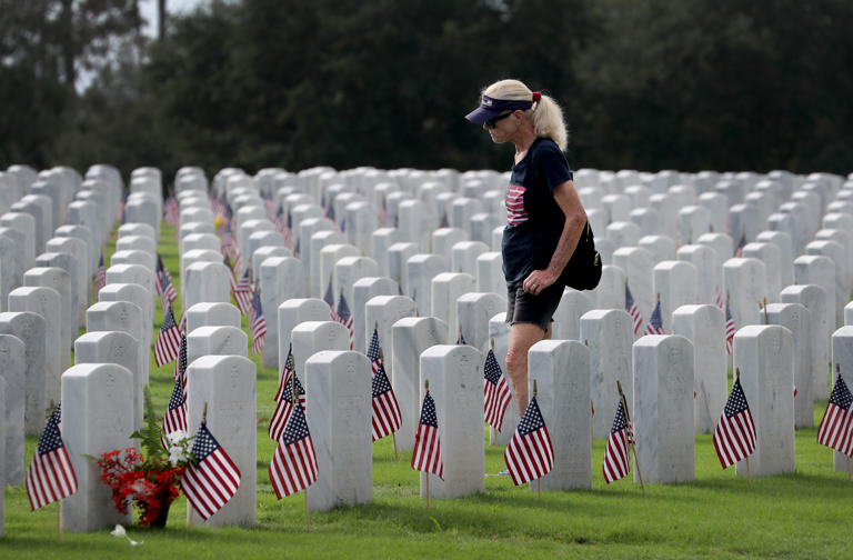 Carol Foland, of West Palm Beach, walks through South Florida National Cemetery on a previous Memorial Day.