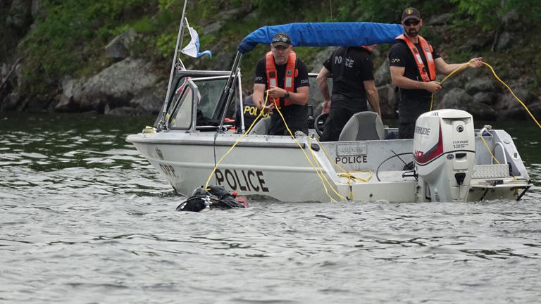 Members of the Ontario Provincial Police (OPP) search the water at Buck Bay on May 21, 2024, following a fatal boat crash over the long weekend.