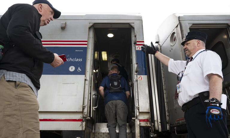 Conductor Robert Vogds, right, directs passengers aboard for the inaugural trip of Amtrak's Borealis train to Chicago at Union Station in St. Paul on Tuesday, May 21, 2024. The new service joins the current Empire Builder route, providing twice-daily trains to and from St. Paul and Chicago.