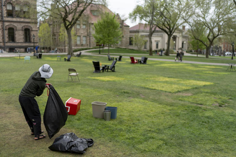 A protester cleans up after a pro-Palestinian demonstration ended peacefully at Brown University.