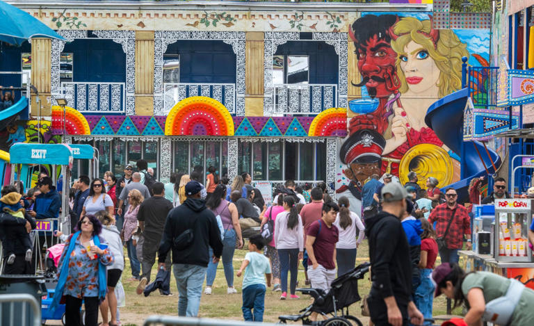 Festival goers walk among the various rides at the 63rd Annual Strawberry Festival in Garden Grove on Saturday, May 26, 2023.