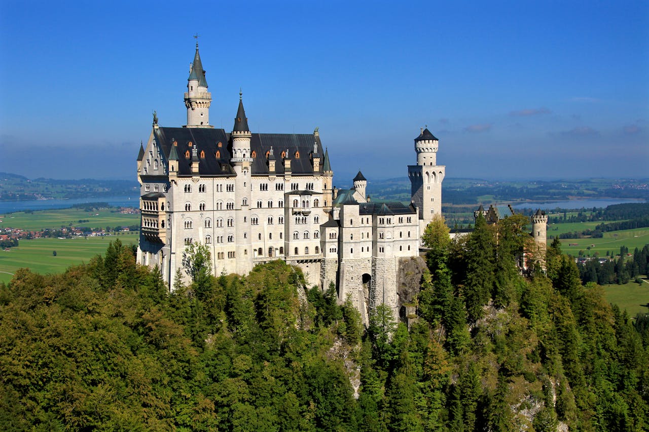 <p>Neuschwanstein Castle is a 19th-century historicist palace on a rugged hill of the foothills of the Alps in the very south of Germany, near the border with Austria.</p>  <p>It was once home to King Ludwig II, and happens to be the inspiration behind Disneyland’s Sleeping Beauty Castle.</p>