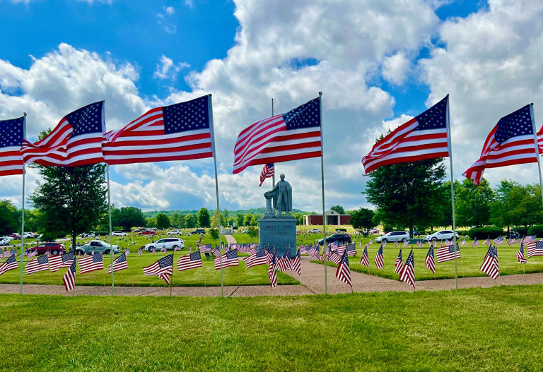 U.S. Flags surround the statue of President James K. Polk during the Polk Memorial Gardens' 37th annual Memorial Day service.