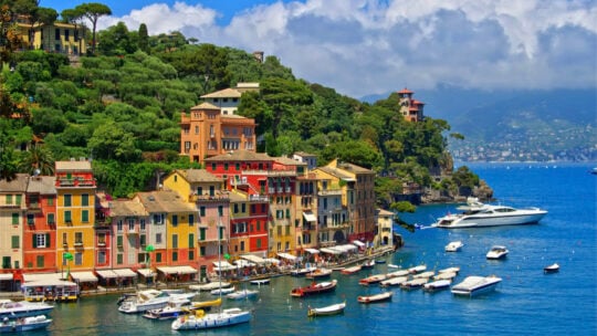 <p><span>Portofino, a picturesque crescent-shaped village, is a renowned retreat for the elite. Its azure waters teem with luxurious yachts, inviting swimming and diving enthusiasts. Beyond its spellbinding facade, Portofino exudes tranquility, offering the perfect setting for relaxation. History buffs can explore nearby attractions like Castello Brown, a historic fortress boasting panoramic views of Marina di Portofino, and Abbazia di San Fruttuoso, a 10th-century monastery accessible only by foot or ferry. With its natural beauty and cultural intrigue blend, Portofino promises a memorable escape for travelers seeking </span><span>luxury</span><span> and serenity.</span></p>
