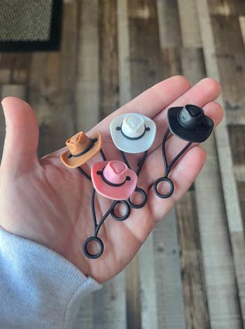 Cowboy hat straw toppers in white, pink, brown, and black