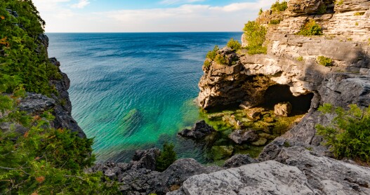 <a>At the cross-section of Lake Huron and Georgian Bay in Ontario, Canada, cruise passengers will see photogenic shorelines like the Grotto in Bruce Peninsula National Park.</a>