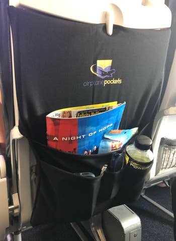 the pocket holding magazines and a water botttle