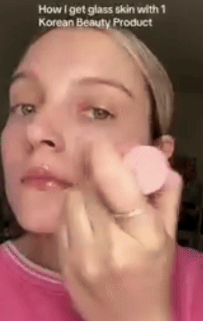 Model demonstrates application of a multibalm on face