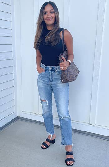 full length view of reviewer wearing the black sandals