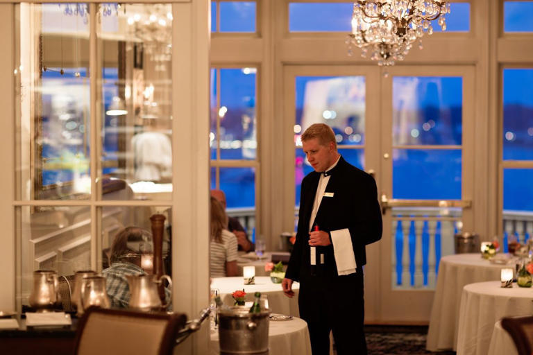 A server checks on a table at Cara restaurant at The Chanler at Cliff Walk in Newport, R.I.