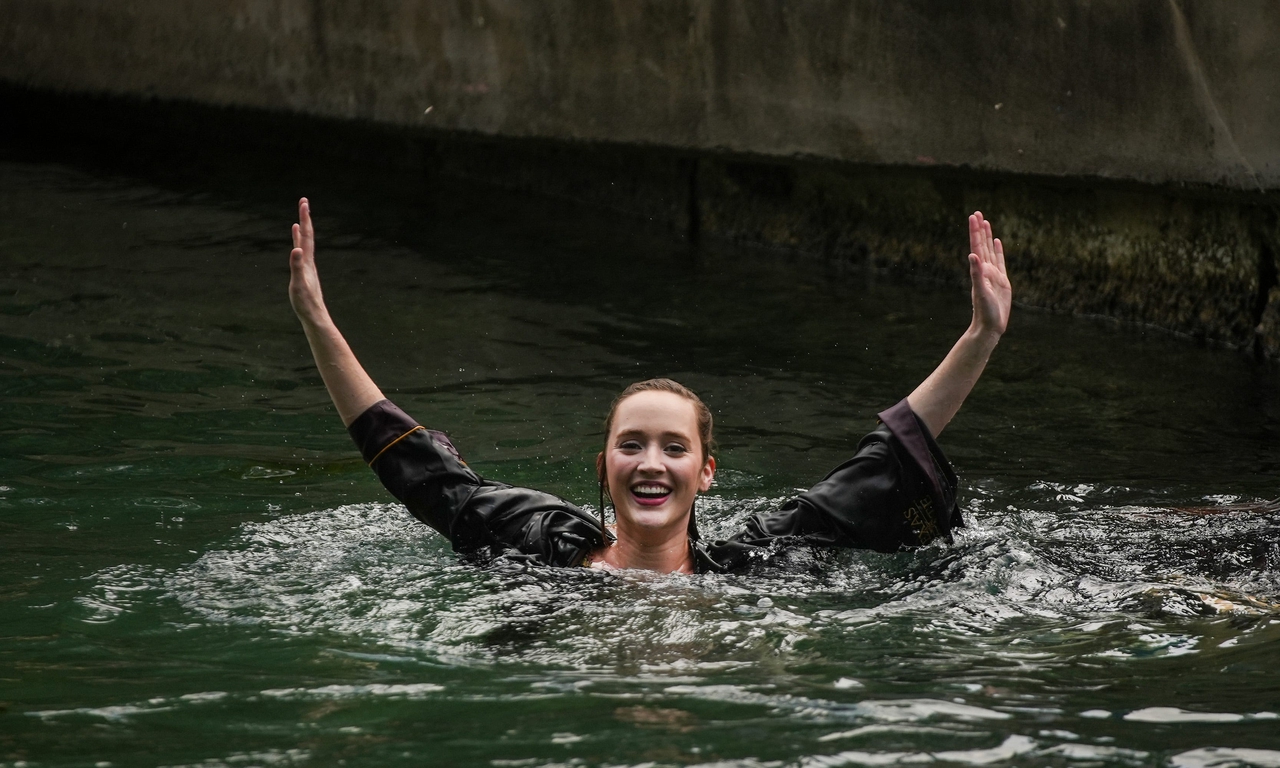 Camryn Mikosh celebrate after jumping into the San Marcos River at Sewell Park. This is after participating in a commencement ceremony at Bobcat Stadium in San Marcos on Thursday, May 9, 2024.