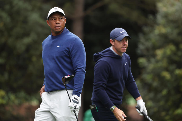 Tiger Woods and Rory McIlroy look on from the 11th tee during a practice round prior to the 2023 Masters Tournament at Augusta National Golf Club on April 03, 2023 in Augusta, Georgia. (Photo by Christian Petersen/Getty Images)