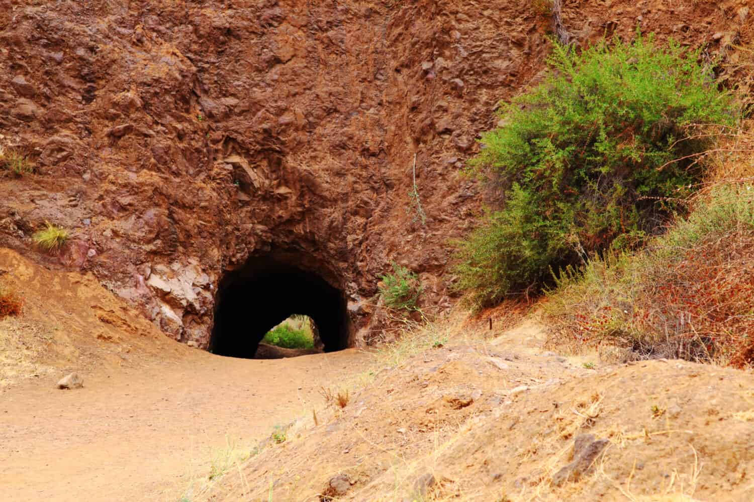 <p>The Bronson Caves not only give a majestic view of the monument, but they are also the home of the iconic Batcave from the <a href="https://www.californiacuriosities.com/bronson-canyon-bat-cave/" rel="noopener">_Batman_ show in the sixties.</a> It is also home to scenes from films like _Army Of Darkness_ and _The Searchers_. It is a relatively short hike compared to the other trails on the list, clocking in under an hour, but it is an effective trail to get some amazing shots of the sign itself. To access the caves, park at the parking lot at the end of Brush Canyon and you'll reach a gate by Camp Hollywoodland. After that gate, keep going north through the Brush Canyon and you'll be there in no time.</p>