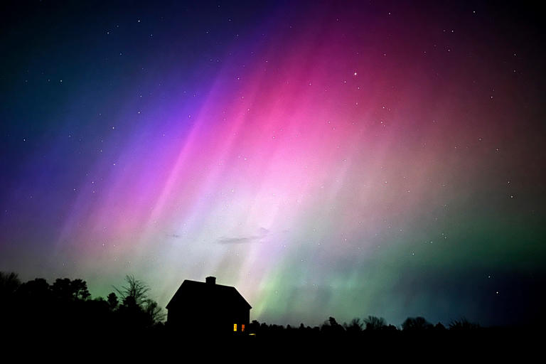 The northern lights flare in the sky over a farmhouse, May 10, in Brunswick, Maine.