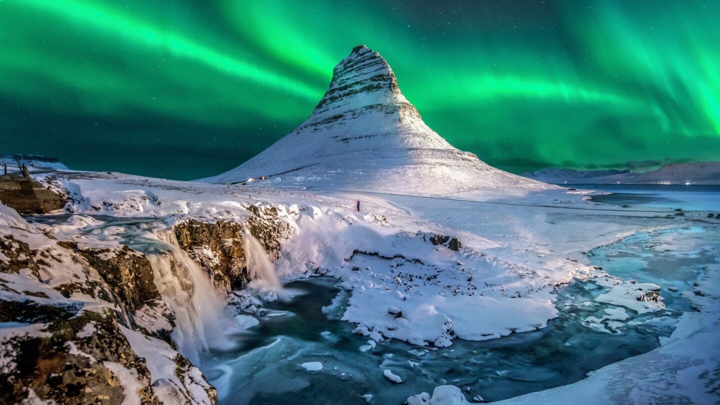 <p>Imagine standing under a sky lit by the aurora borealis, the green and blue lights dancing above snowy mountains. It's a breathtaking sight that makes you feel like you're in another world, far away from the grind of daily life. Mount Kirkjufell stands as a striking landmark on Iceland’s Snæfellsnes Peninsula. It is often claimed to be the most photographed mountain in the country and truly one of the most beautiful sights in the world. </p>