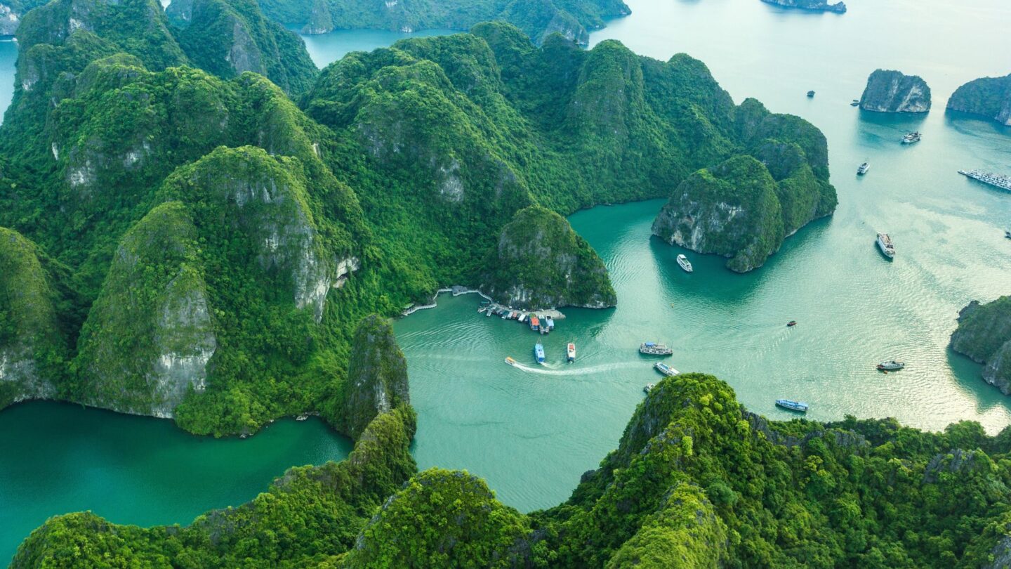 <p>Imagine a quiet bay surrounded by huge limestone cliffs, with just a few boats floating gently on the water; the scene looks straight out of a movie. It looks so surreal that you almost start wondering whether this place exists in real life. Ha Long Bay in Vietnam is exactly that place, and it looks as stunning in real life as it does in pictures. </p>