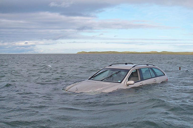 Car submerged in water on Holy Island causeway