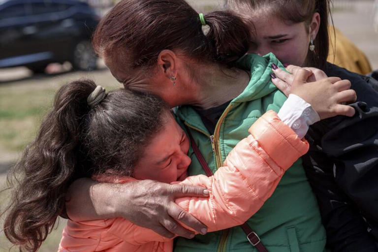 Khrystyna Pyimak, 11, hugs her mother, Oksana Velychko, after evacuation from Vovchansk, Ukraine, on Sunday. ((Evgeniy Maloletka / Associated Press))