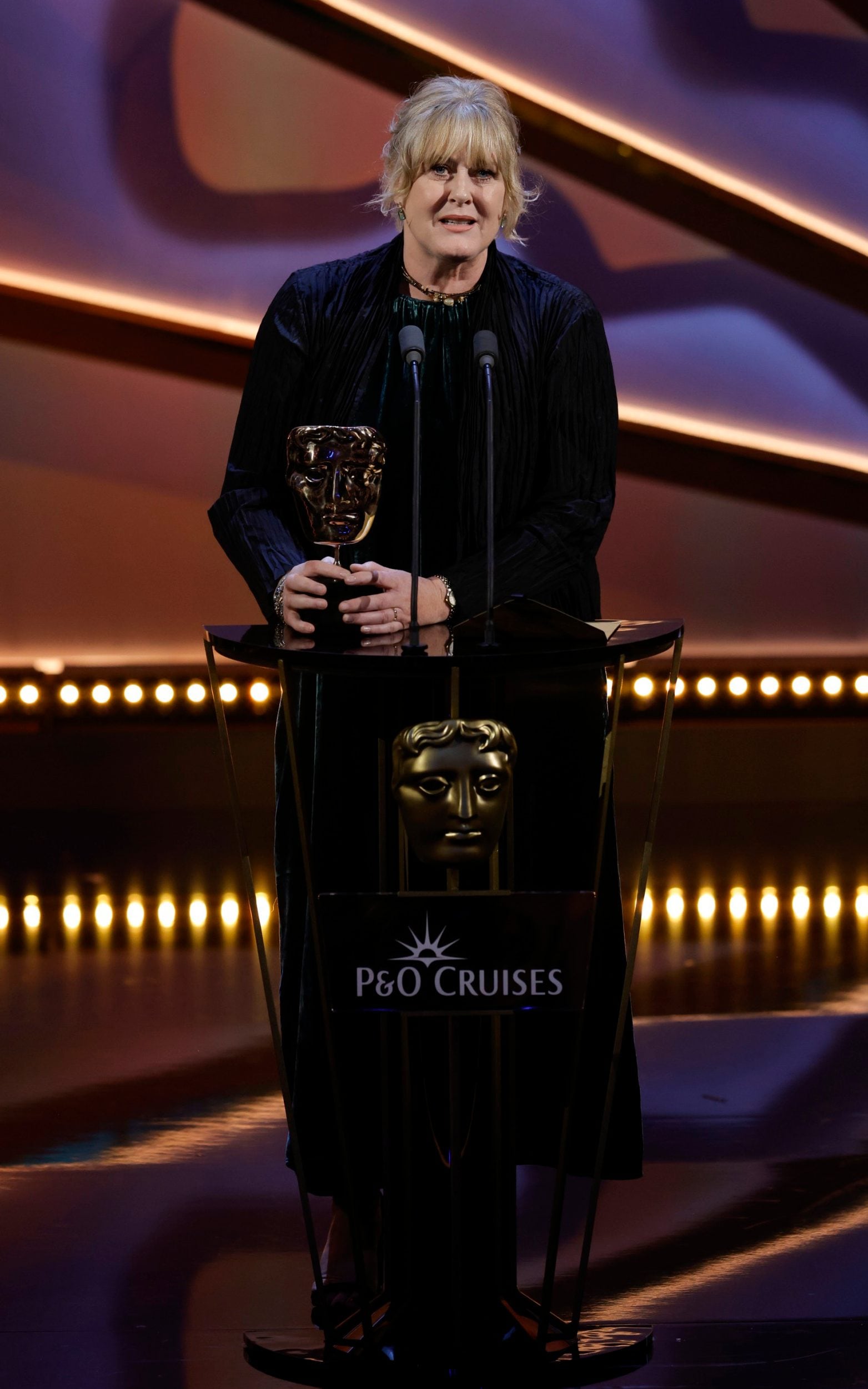<p>Lead actress winner Sarah Lancashire skipped the red carpet but opted for a green velvet dress to collect her award for her performance in Happy Valley. </p>