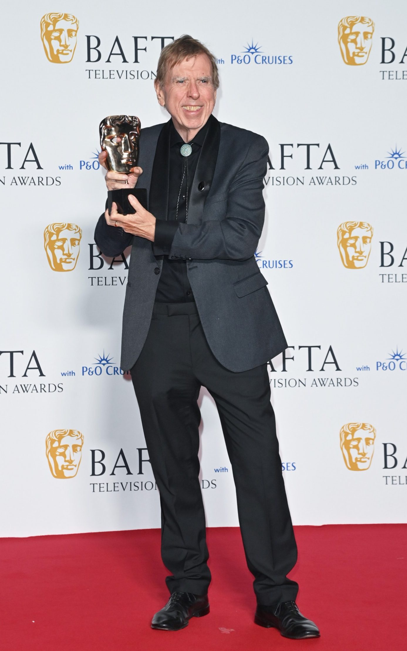 <p>Best actor winner Timothy Spall opted for a grey blazer and bolo tie. </p>