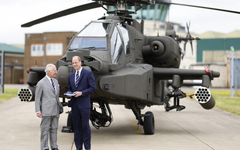 The King hands over the role of Colonel-in-Chief of the Army Air Corps to Prince William with an Apache in the background - Max Mumby/©Max Mumby