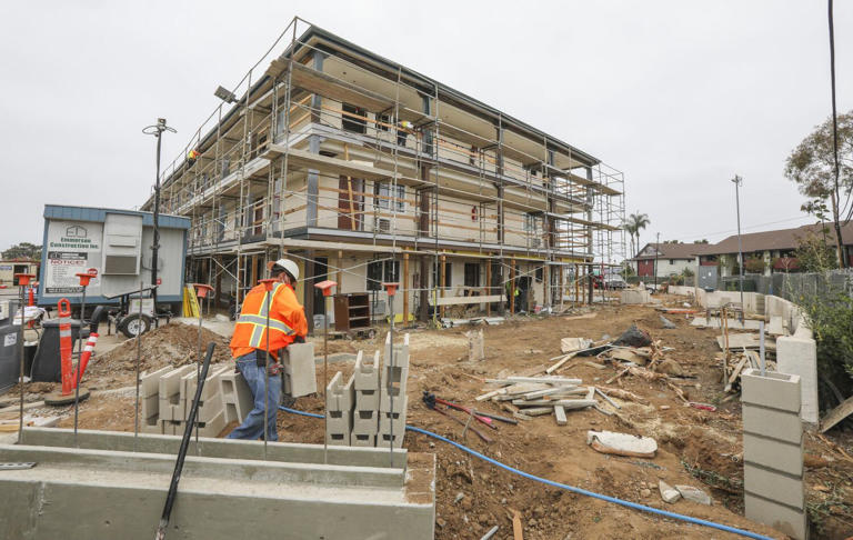 Construction crews work on the completion of Father Joe's Villages 82 unit affordable housing project called Benson Place on June 23, 2020 in San Diego, California.