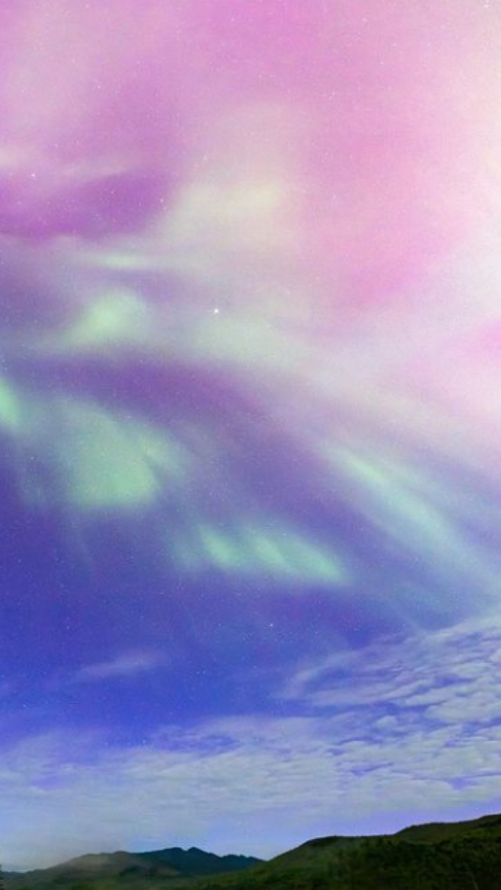 <p>Another beautiful capture of the Aurora Borealis, this sky looks like it was painted by God himself. With shades of mint, pink, and blue, it is picture perfect. </p>